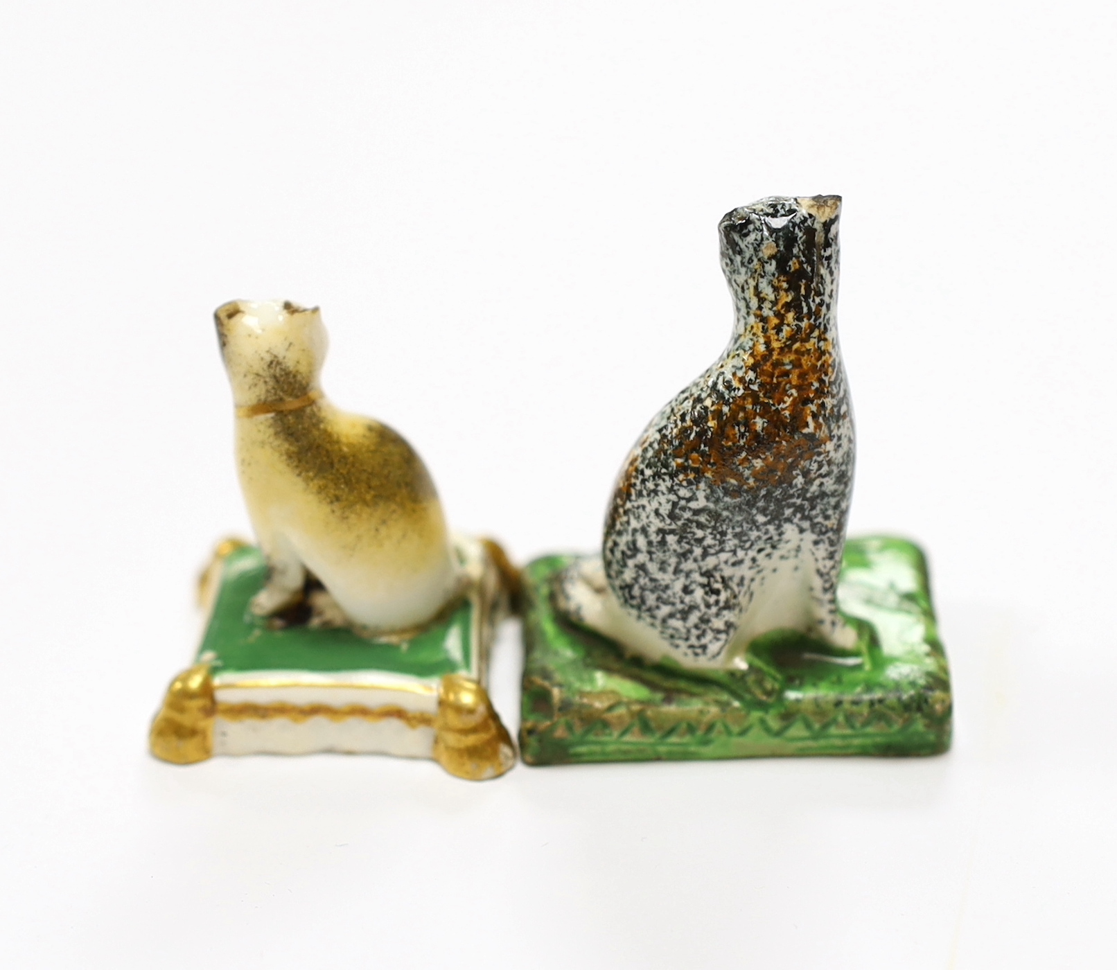 A rare Staffordshire pearlware model of a seated cat, c.1830, 5cm high and a Rockingham porcelain seated model of a cat, c.1830, iron red CL2 mark only